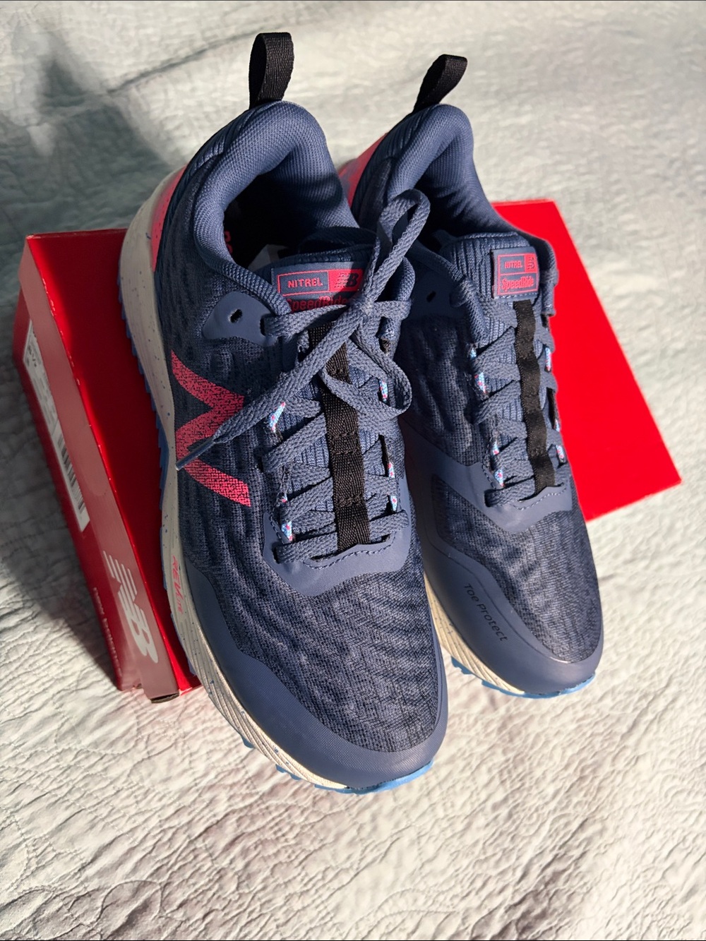 New Balance navy with pink accent running shoes